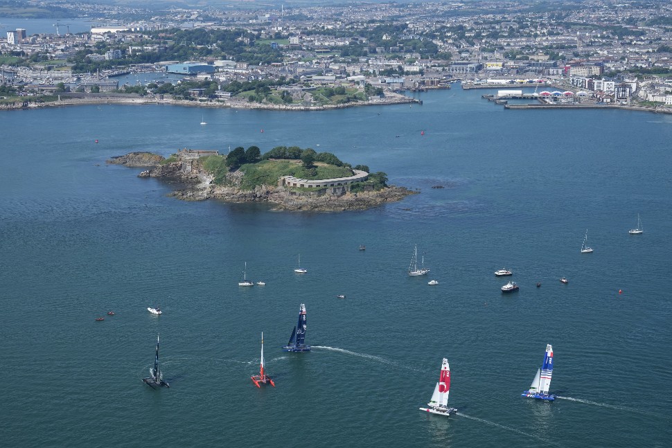 SailGP F50 catamarans in Plymouth Sound with aerial view of the city 